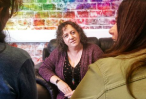 Two people talking comfortably together in an office.